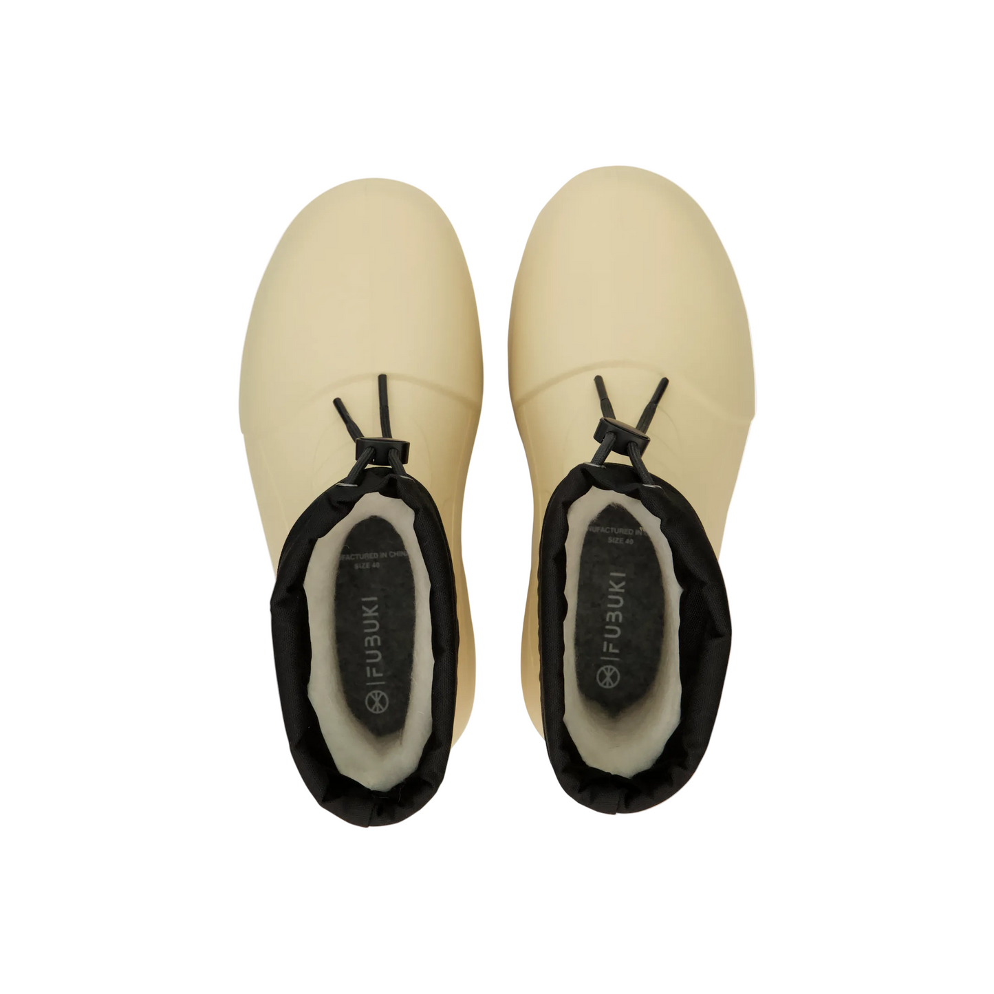 Top view of tan winter boots with black cuffs, cozy lining, ready for snowy mountain adventures