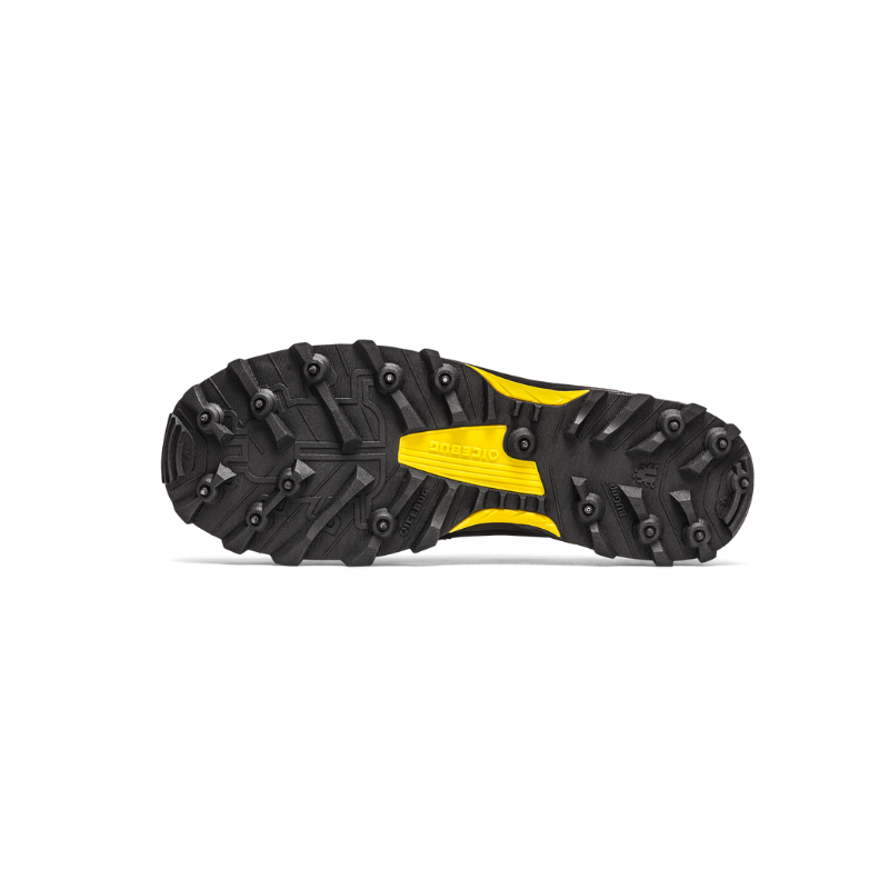Grippy black and yellow trail shoe sole with metal studs, ready for mountain adventures