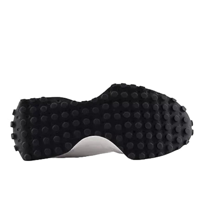 Grippy black sneaker sole with rugged traction, perfect for mountain trail adventures