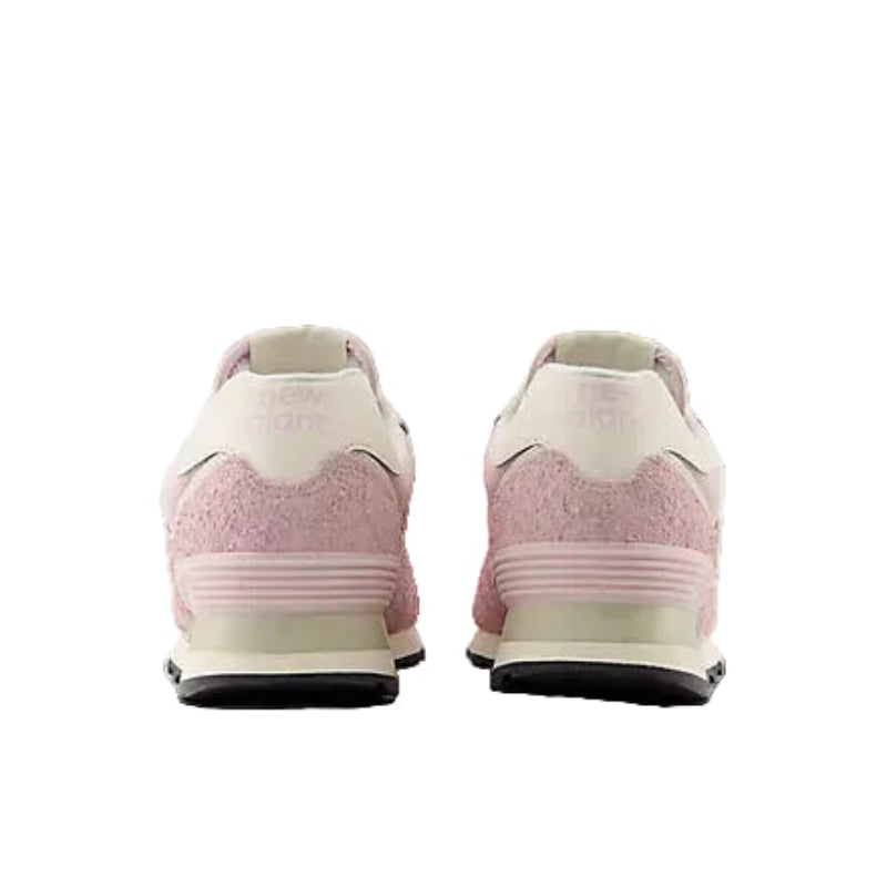 Pink suede sneakers with white accents, seen from the back, perfect for mountain adventures