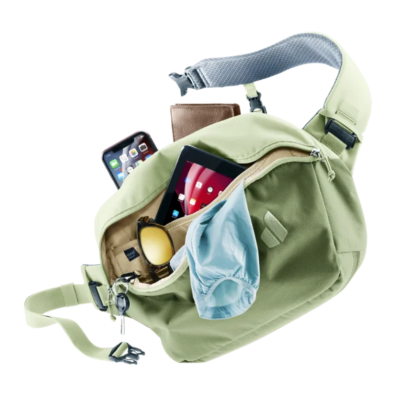 Green waist bag with phone, wallet, and sunglasses on a white background