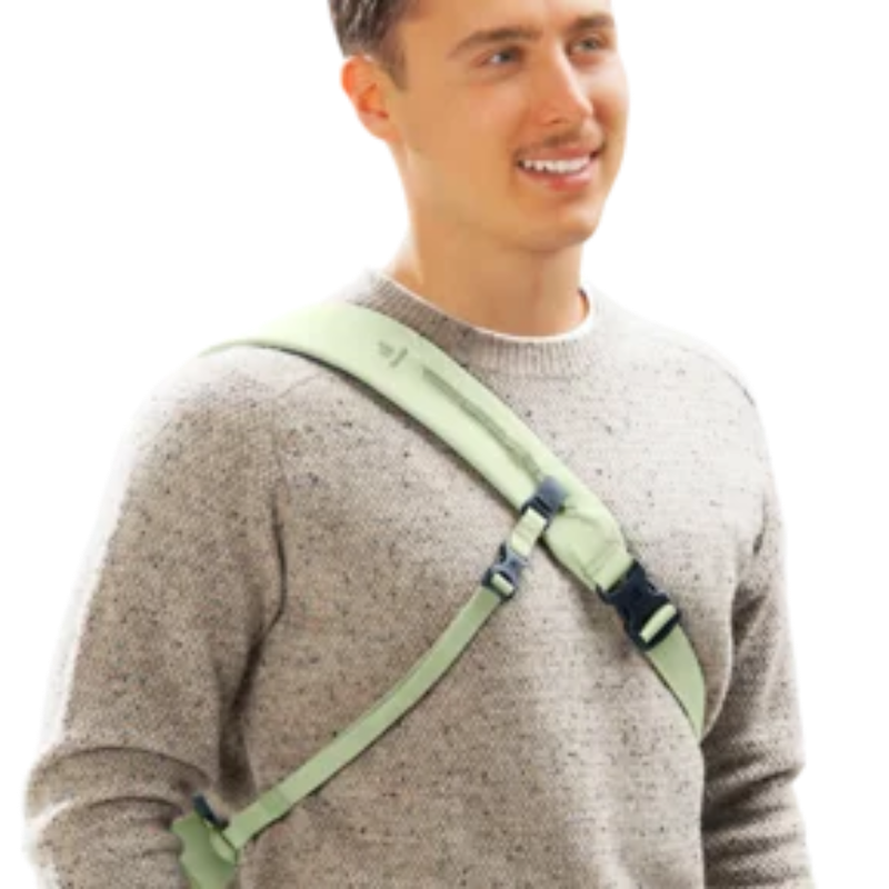 Man wearing a gray sweater with a green shoulder brace on a white background